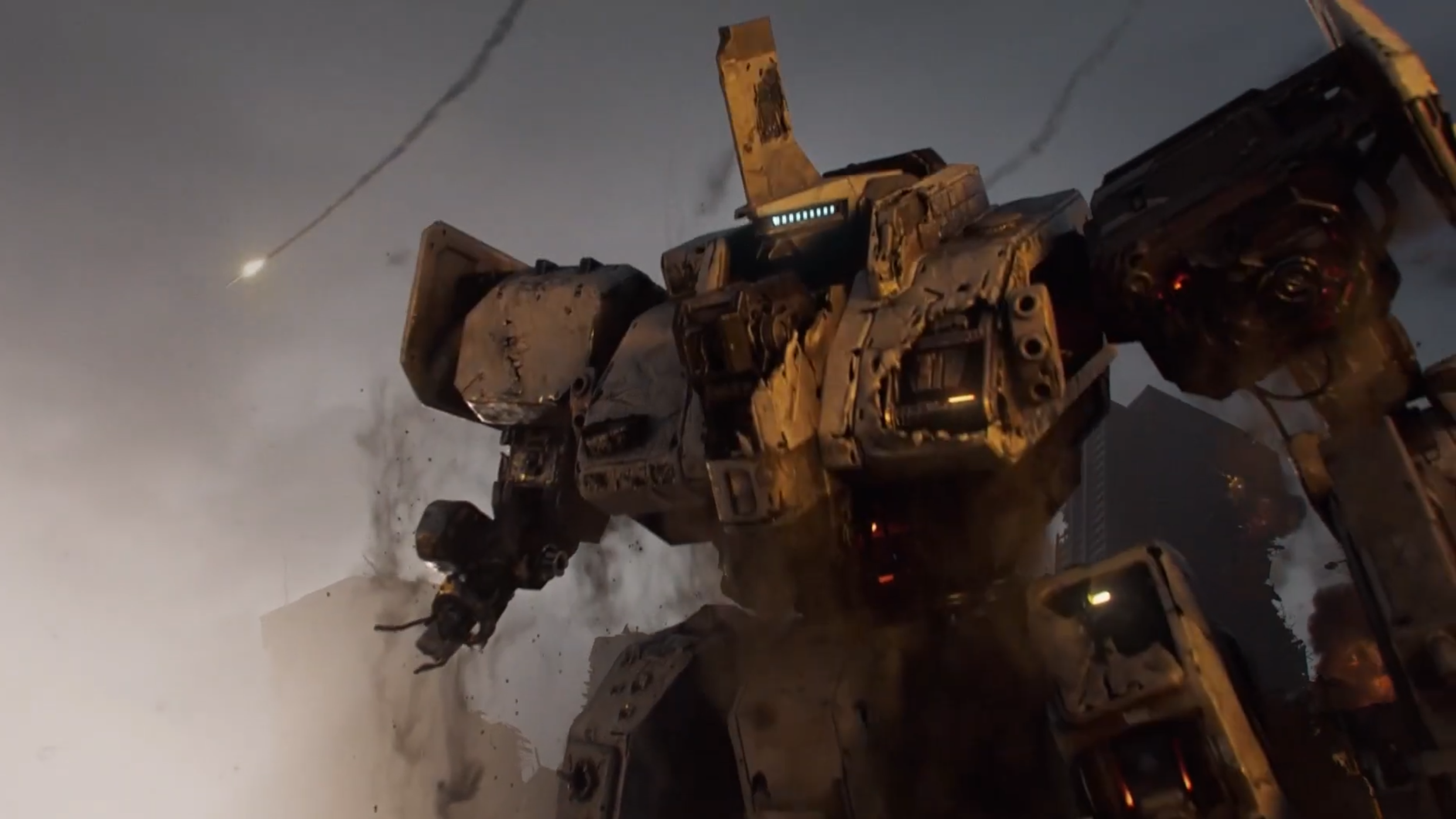 A half-ruined giant robot rises from wreckage. An image from the cinematic trailer for mecha strategy RPG Mecharashi.