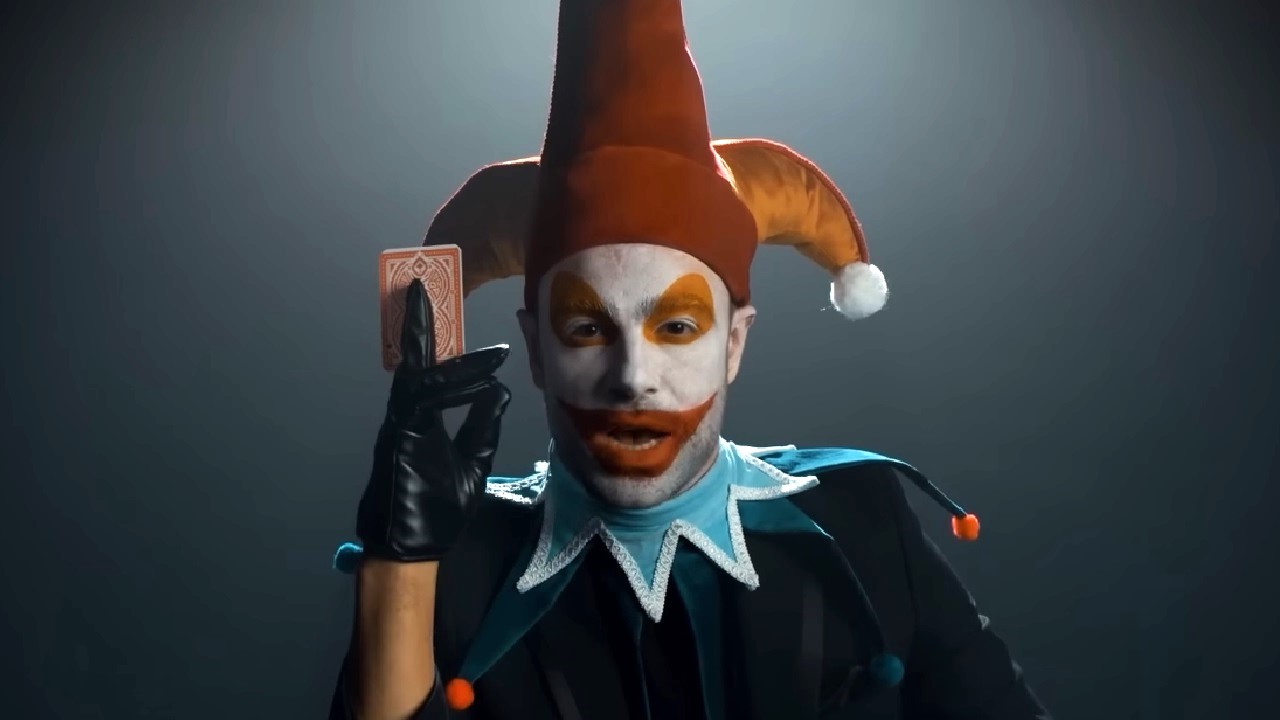 c7xnca9rvdhm2prz3aojam live action Jimbo the Jester from Balatro holding a playing card and addressing the camera
