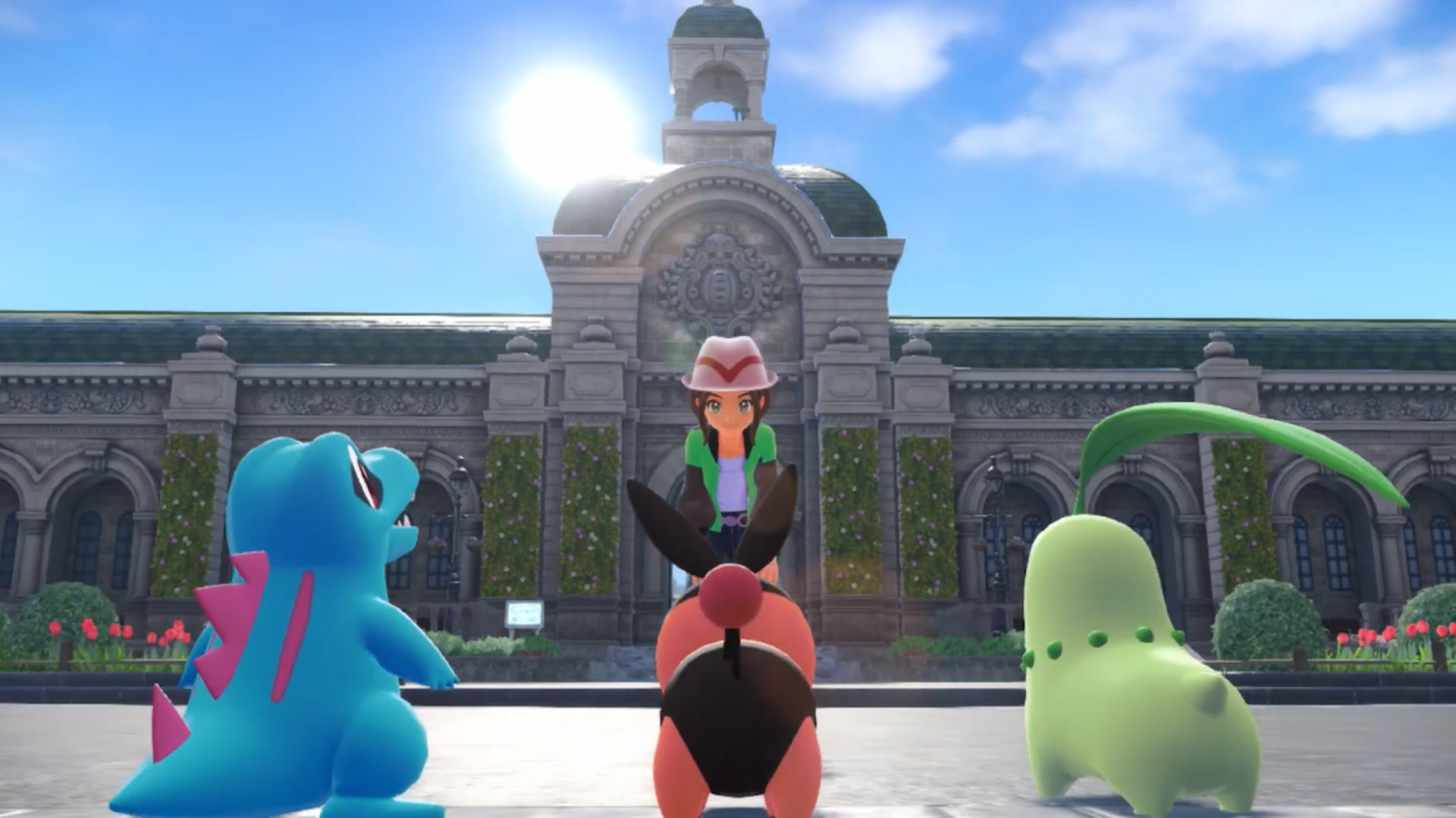 The player character in Pokemon Legends: Z-A looks at the three starter Pokemon, Totodile, Tepig, and Chikorita.