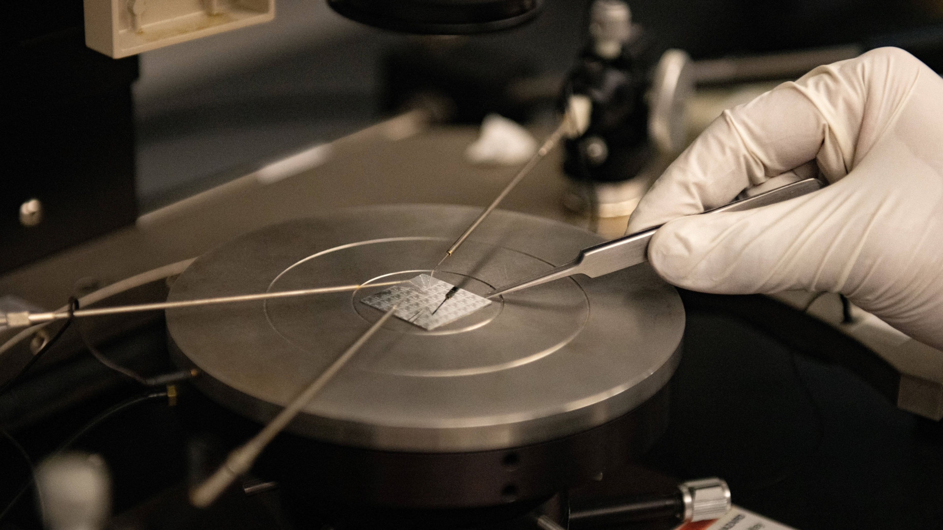 A photo of a liquid metal colloid material being examined with probes