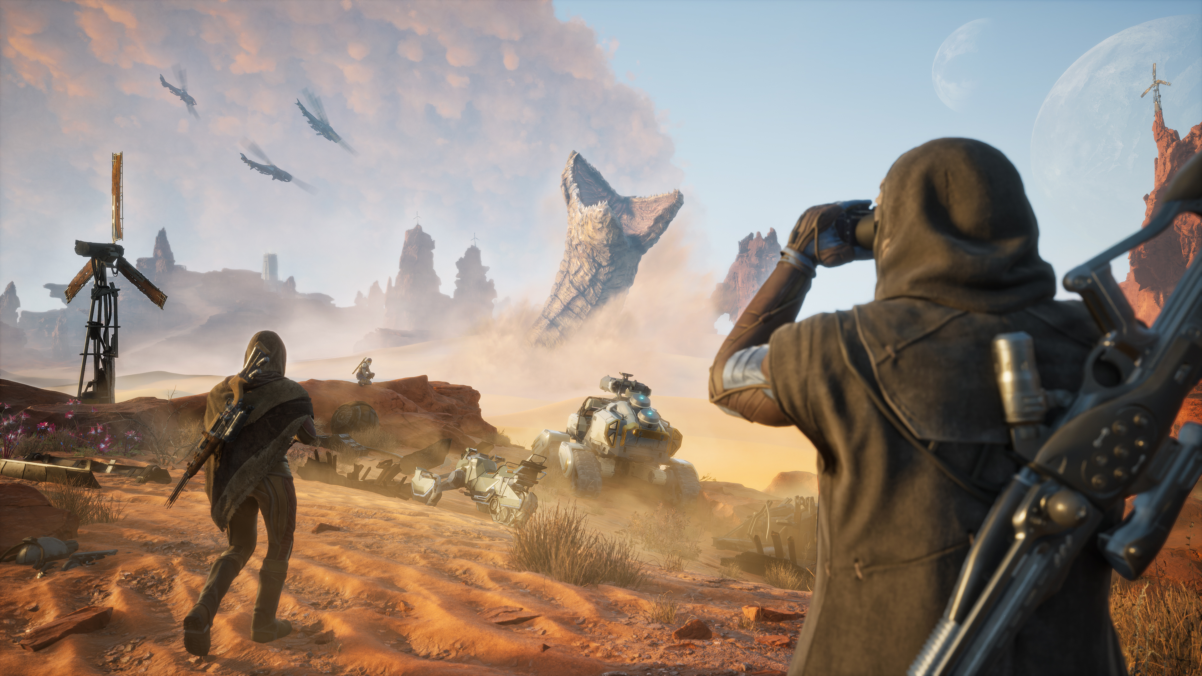 Players survey desert with a sandworm in the distance