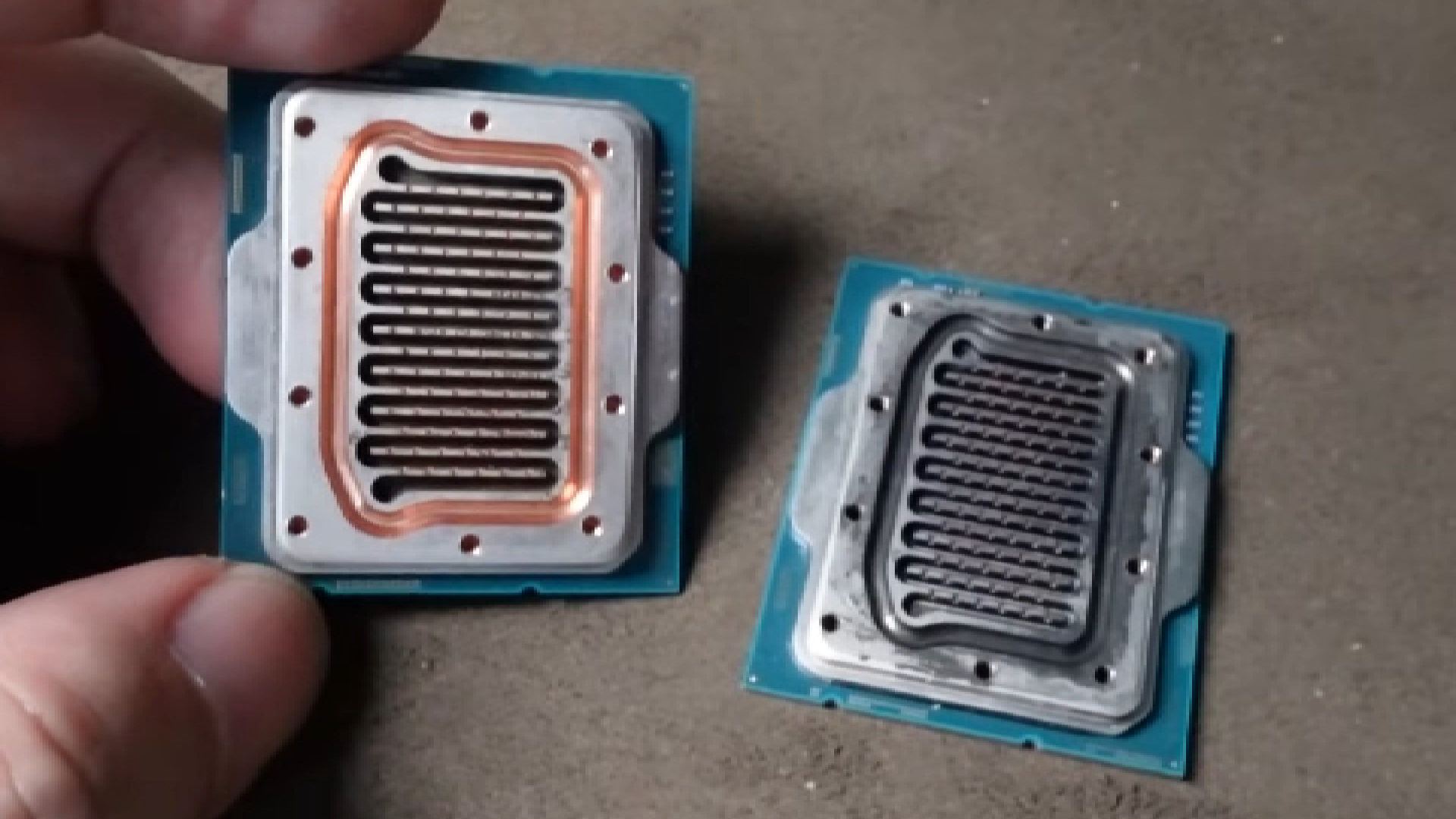 Two Intel CPUs with their heatspreaders CNC-machined into waterblocks