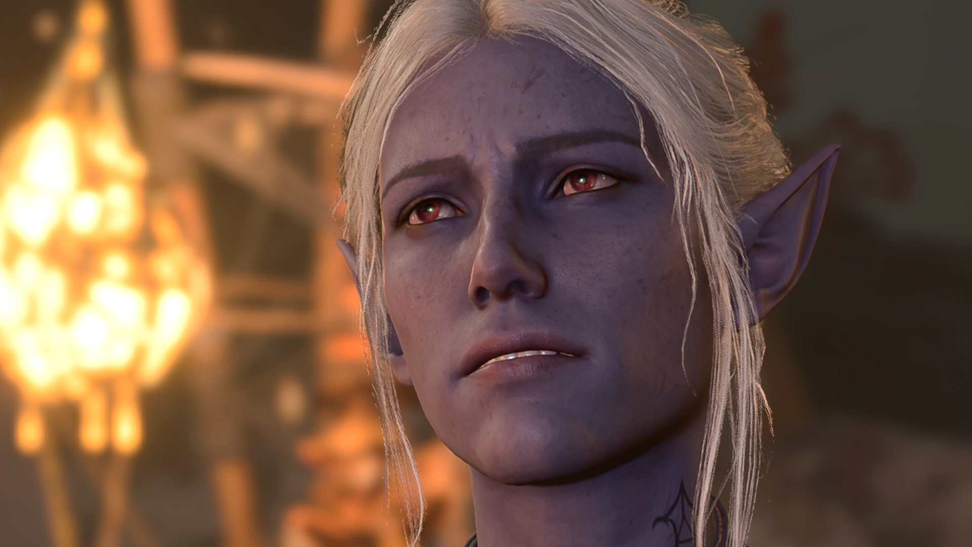 Minthara, a fierce Drow Warrior in Baldur's Gate 3, looks pensive towards the player, illuminated by dim firelight.