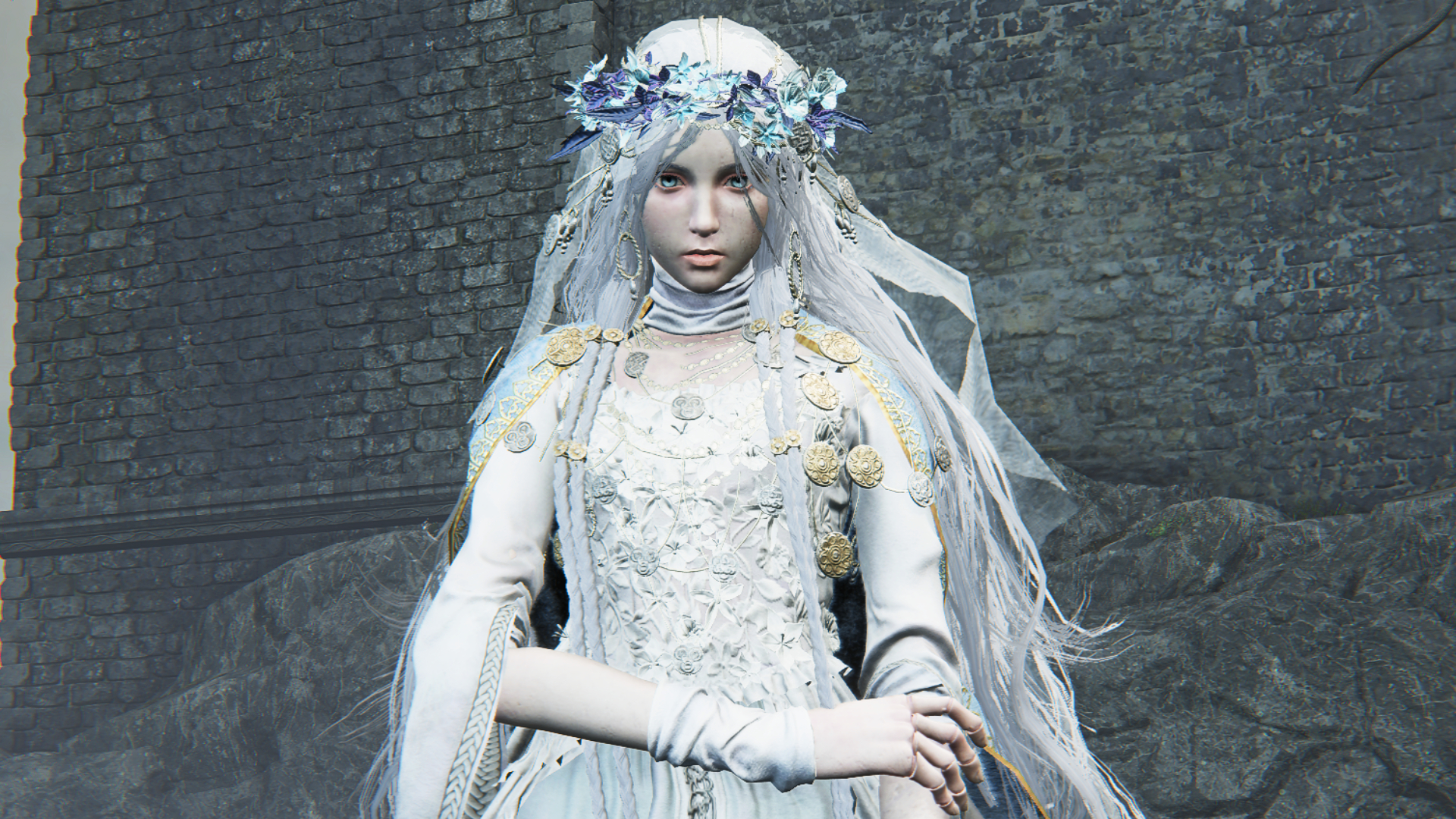 A doll character in white from Elden Ring Nightreign with one arm holding the other and a castle in the background