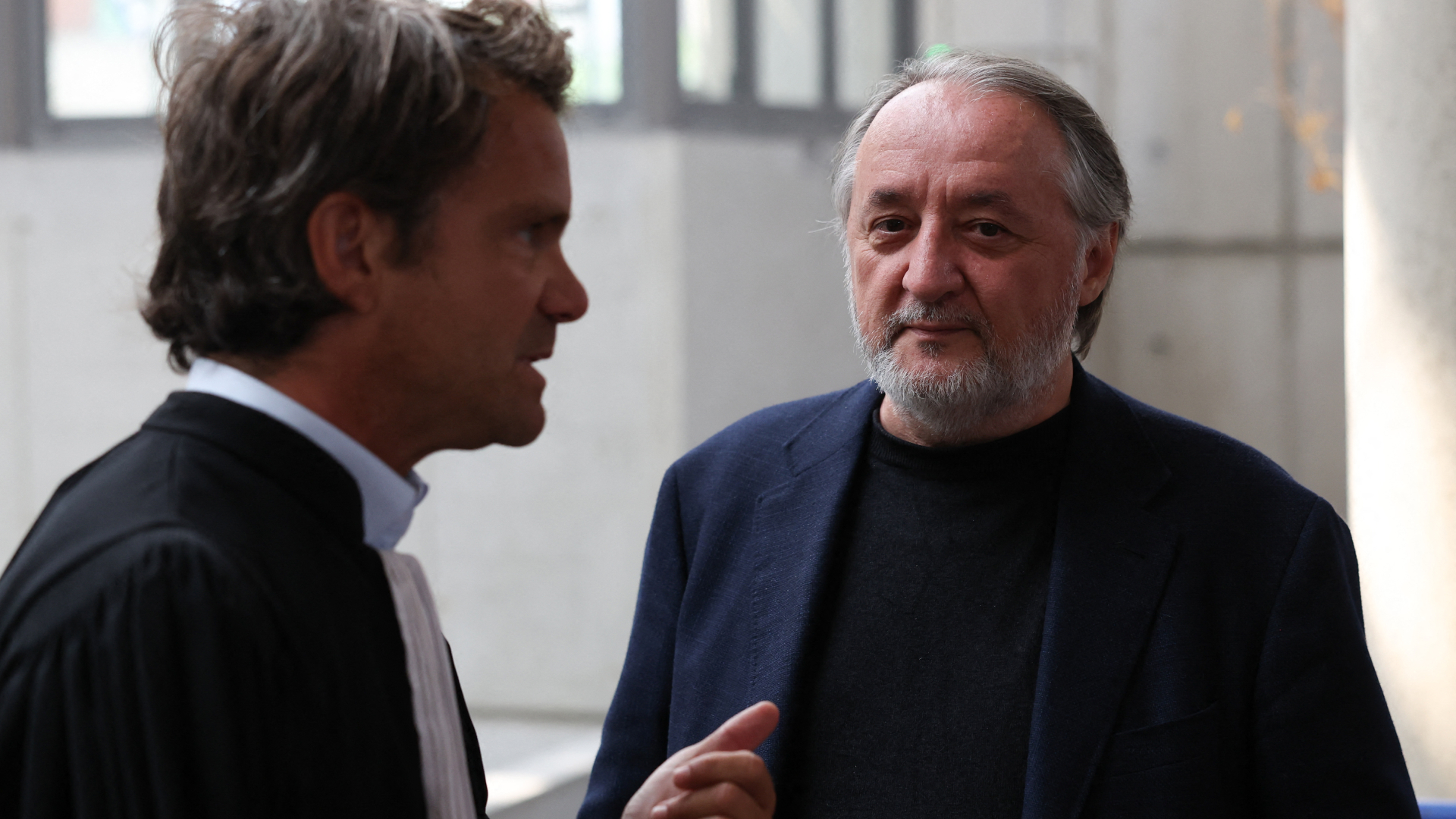 Serge Hascoët (R), former creative director of Ubisoft, speaks with his lawyer as he arrives for the trial of French video game publisher Ubisoft Entertainment former executives for harrasment and sexual assault at the courthouse in Bobigny, suburb of Paris, on June 2, 2025.