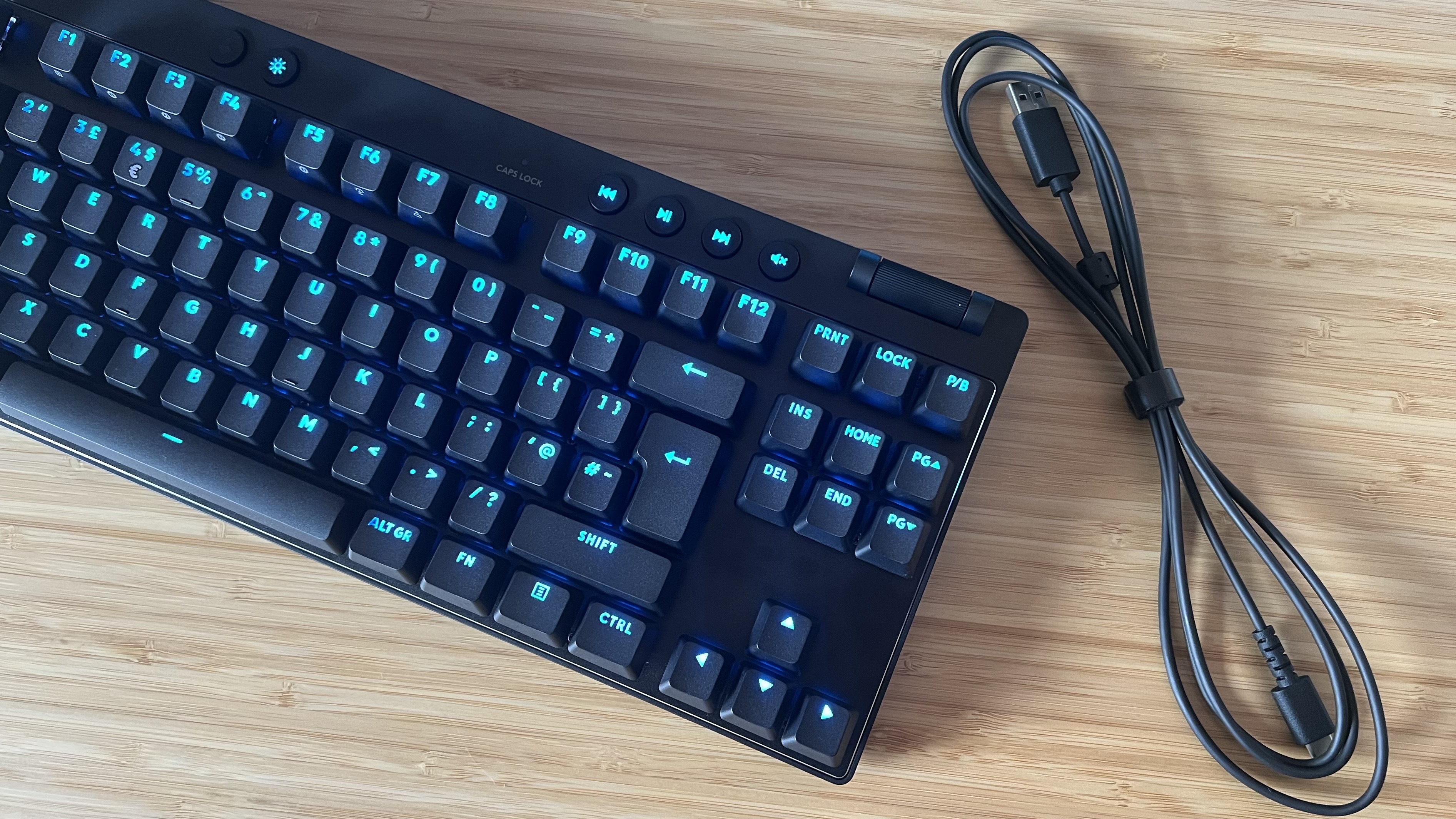 Logitech G Pro X TKL Rapid gaming keyboard with cable on a wooden desk