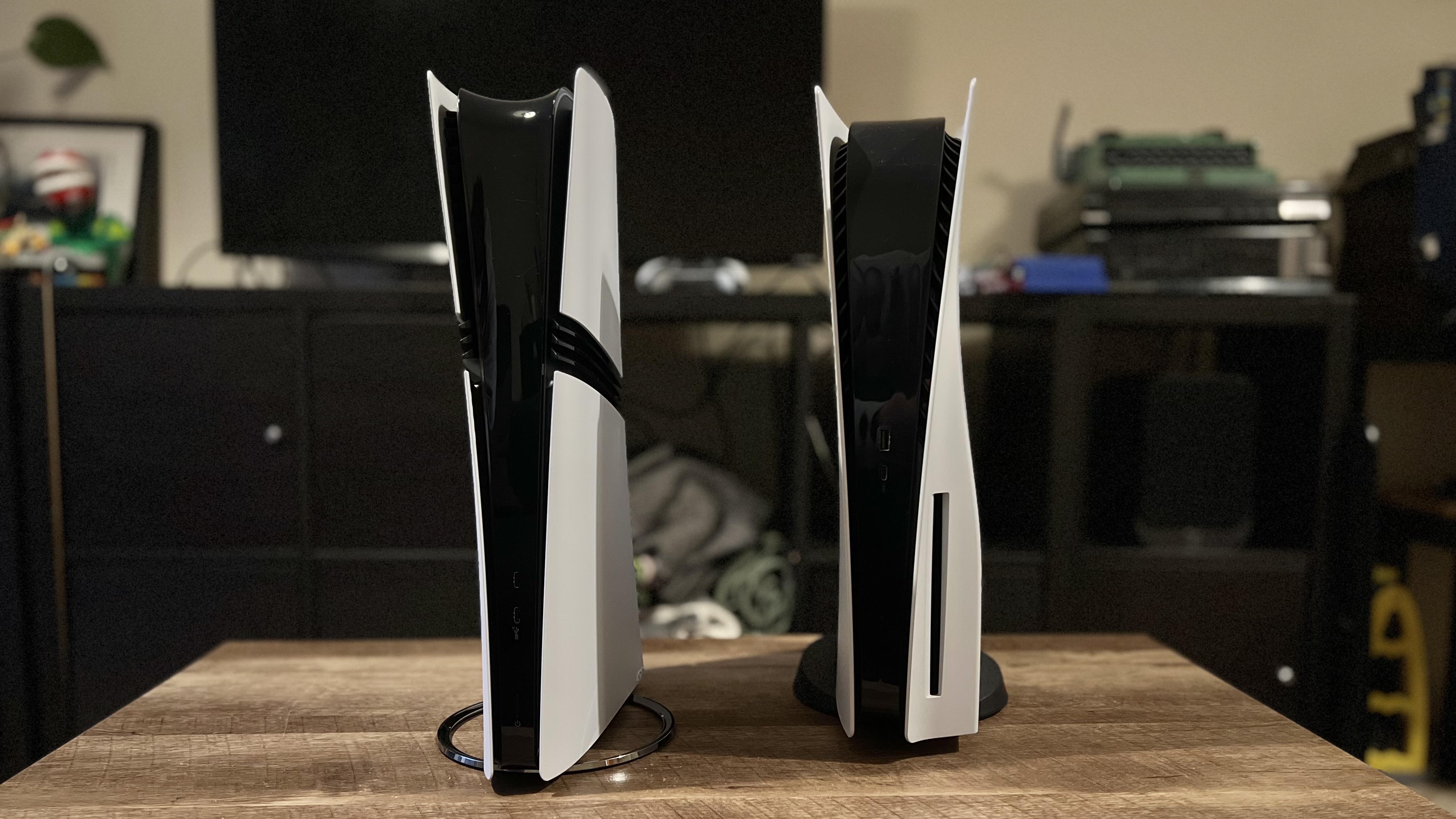 PS5 Pro and PS5 console on a wooden table